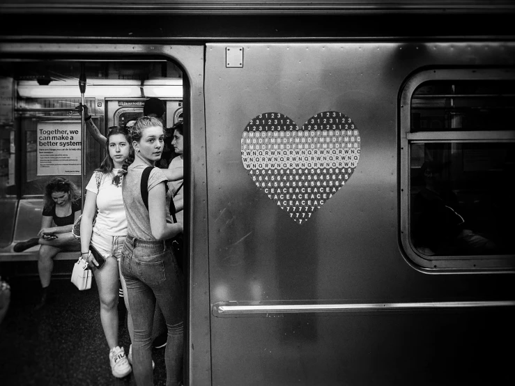 black and white po of woman on train next to passenger