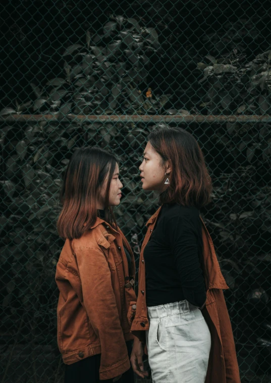 two women are facing each other and talking