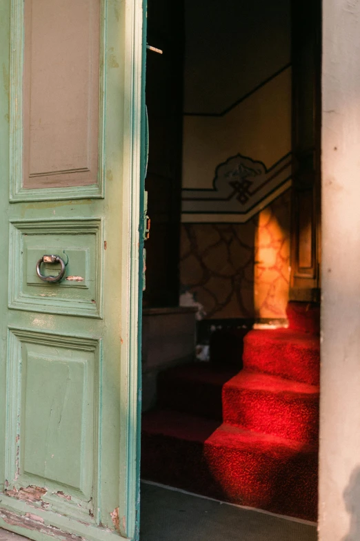 an open door showing the hallway and stairs