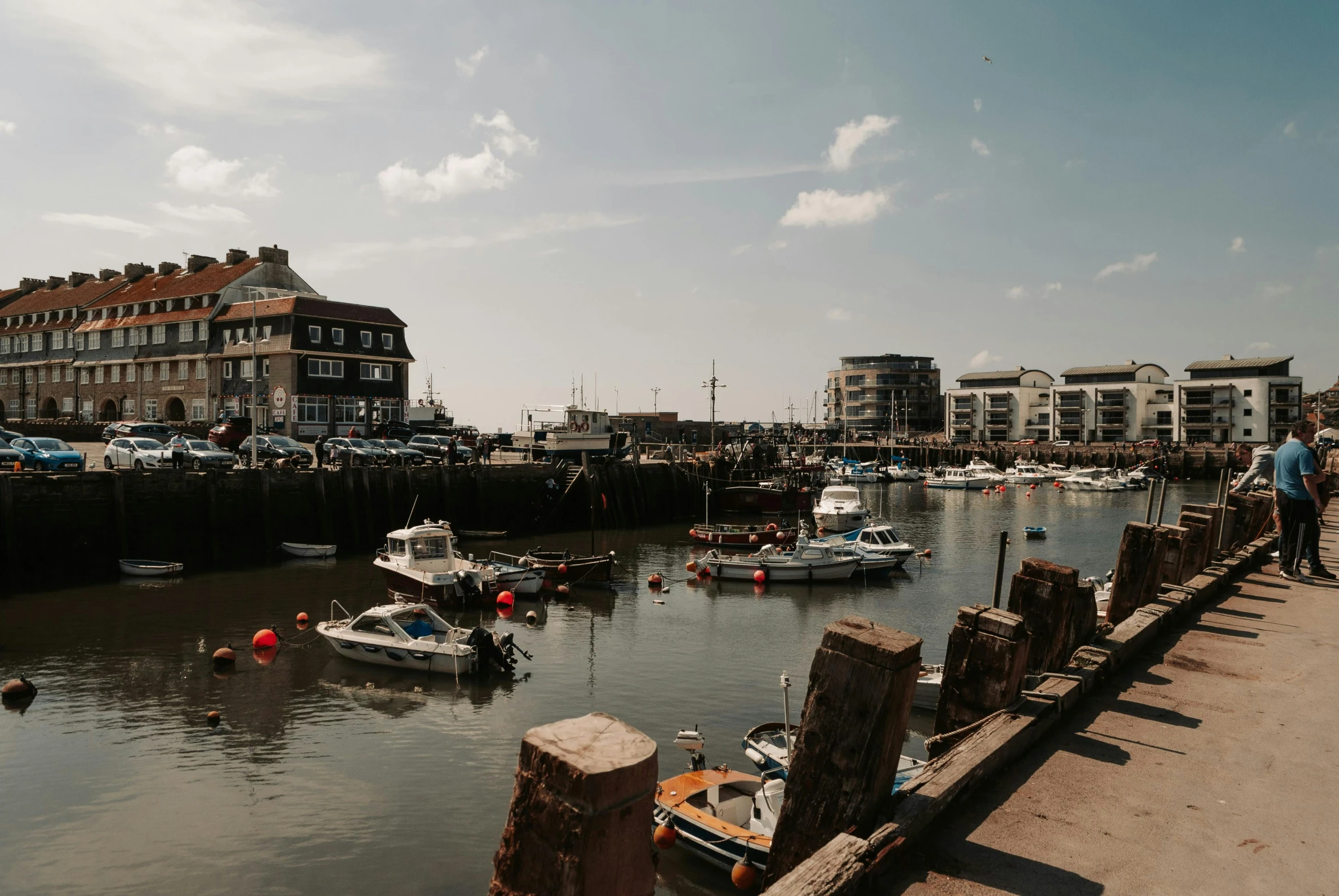 boats docked on a lake, some with older buildings