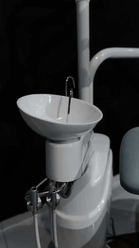 a sink sitting next to a blue chair