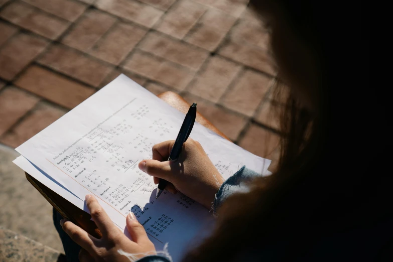 a woman is holding a note taking notes