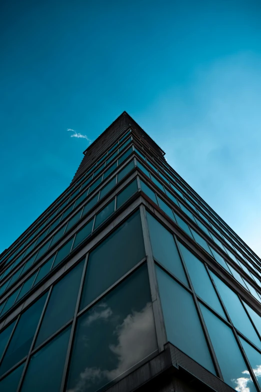 there are clouds in the sky above the building