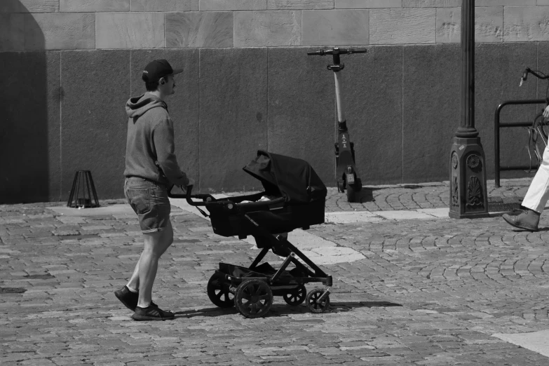 a baby in a stroller near an elderly woman