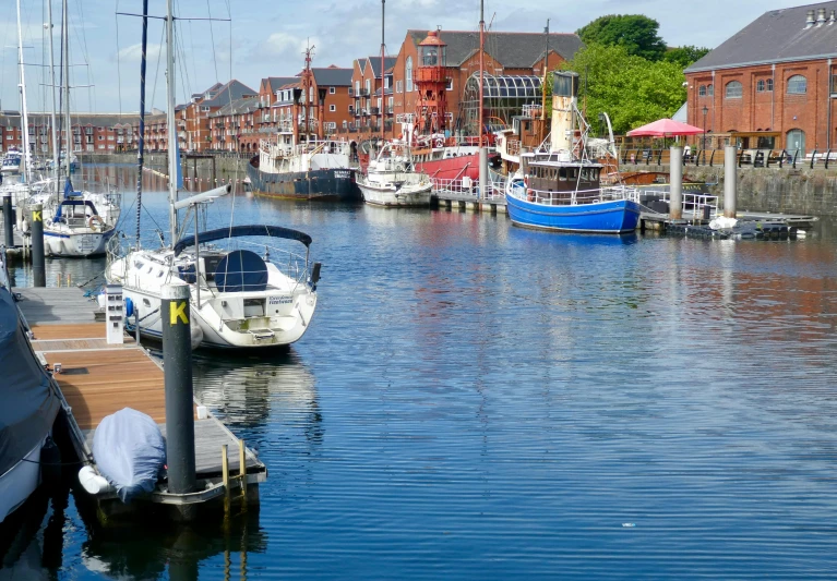 many small boats are docked at the docks