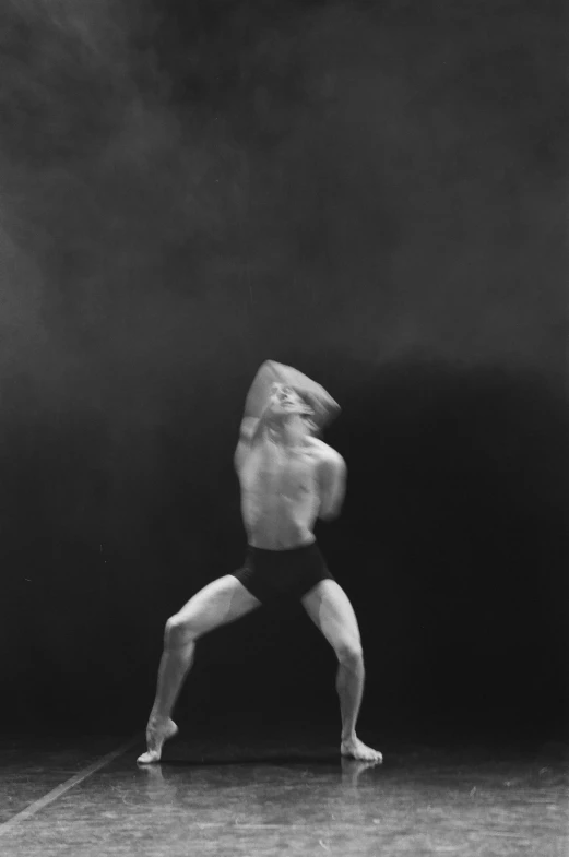 a man standing on one leg with his back turned to the camera