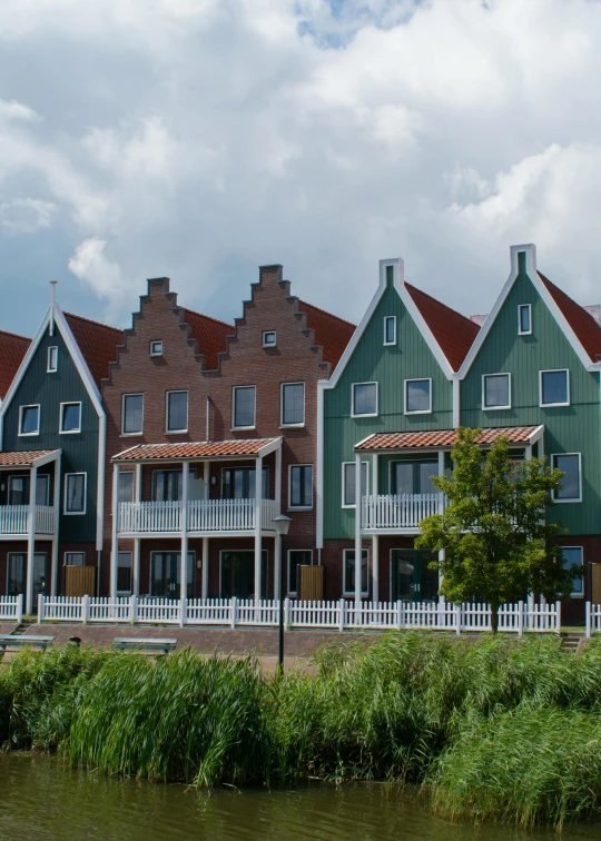 multiple houses are sitting on the river bank