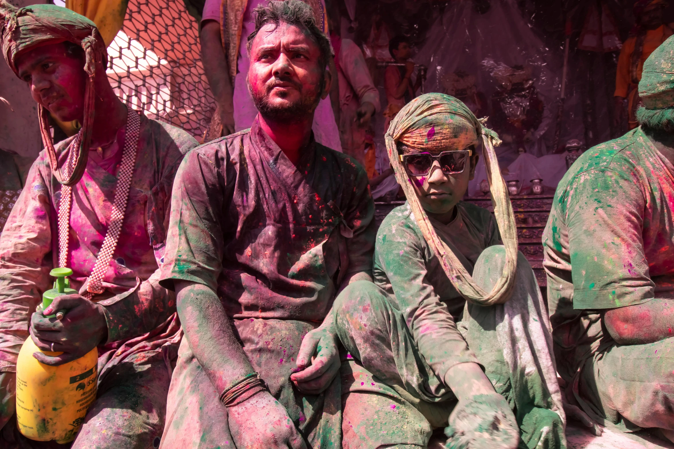 men dressed in paint posing on a bench