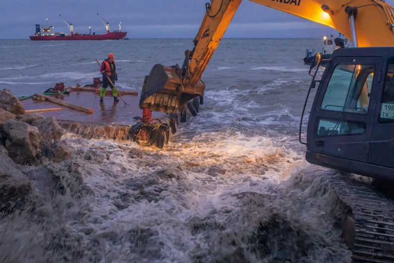 a crane in the water is on top of a boat