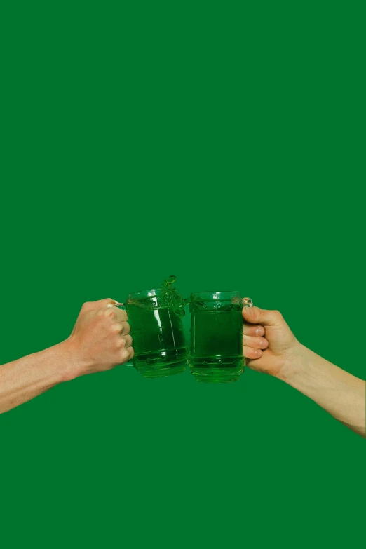 two persons in green cups with their arms wrapped around one another