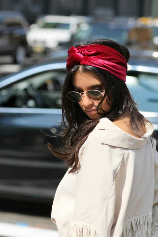 a woman with glasses and a pink headband