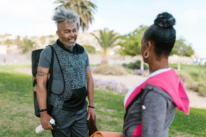 a woman with gray hair talking to a man with white hair