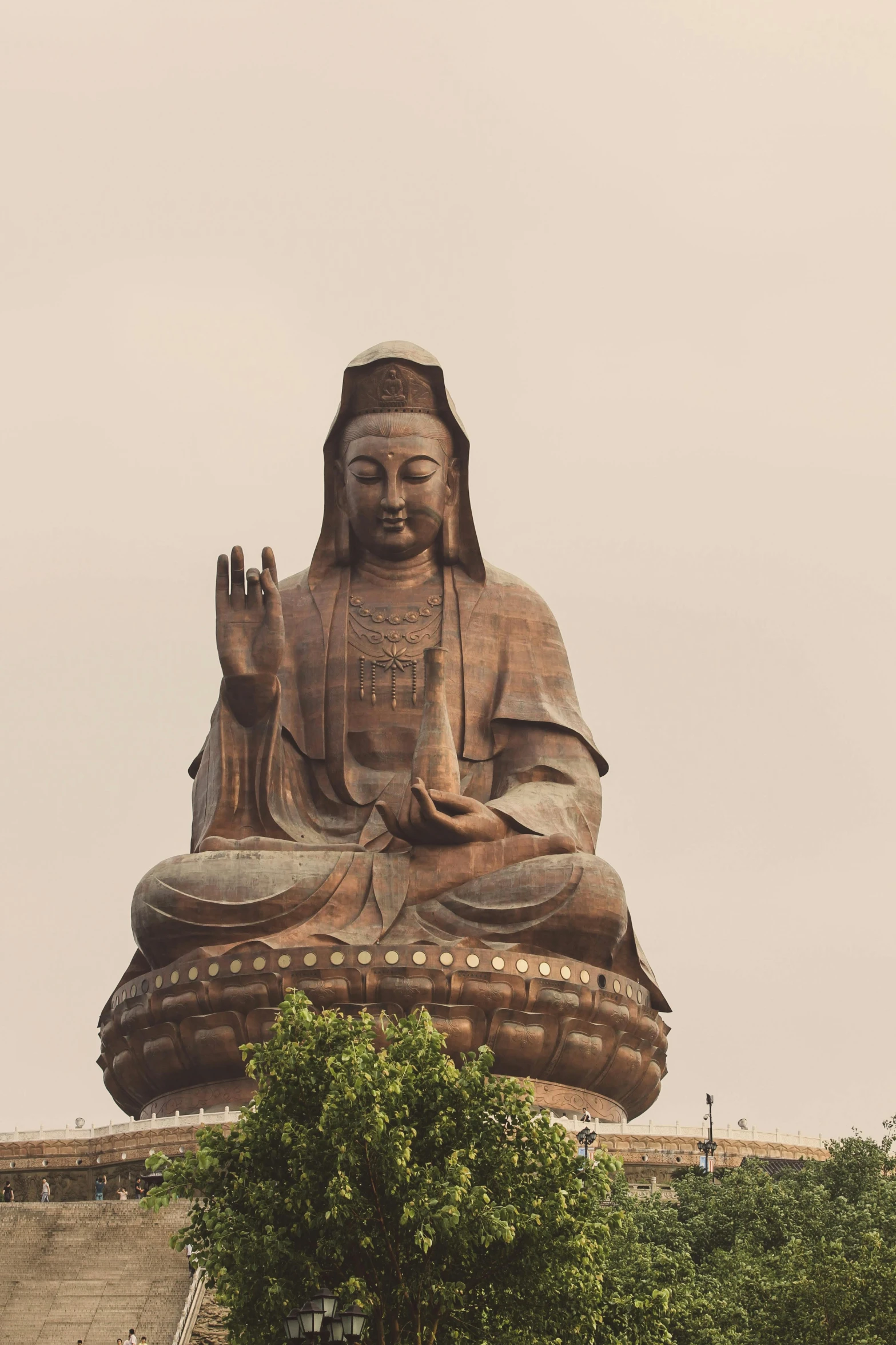 large buddha statue at the top of a hill