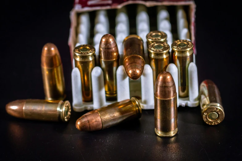 a box filled with bullet shells next to some smaller ones