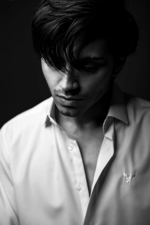 man wearing shirt and white collaring with hair in the wind