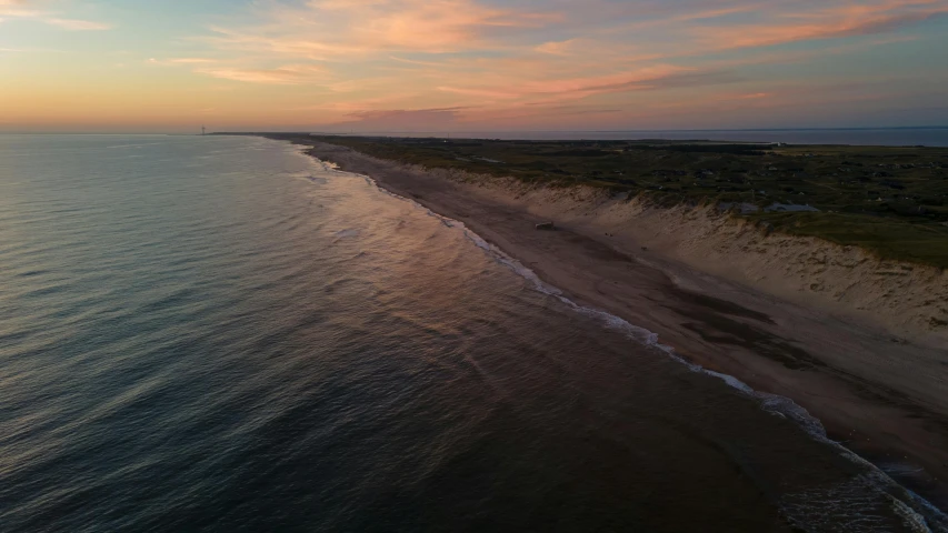 an empty beach next to a very tall body of water