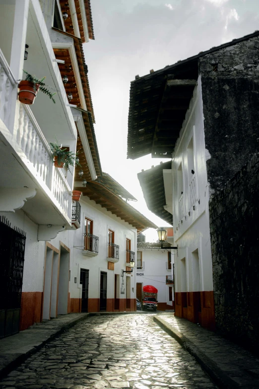 an alley way with small brick street below it