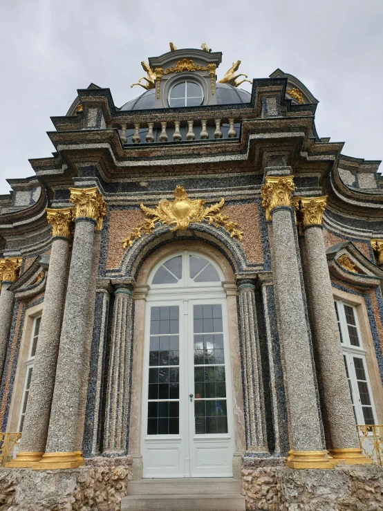 the large building is adorned with gold leaves