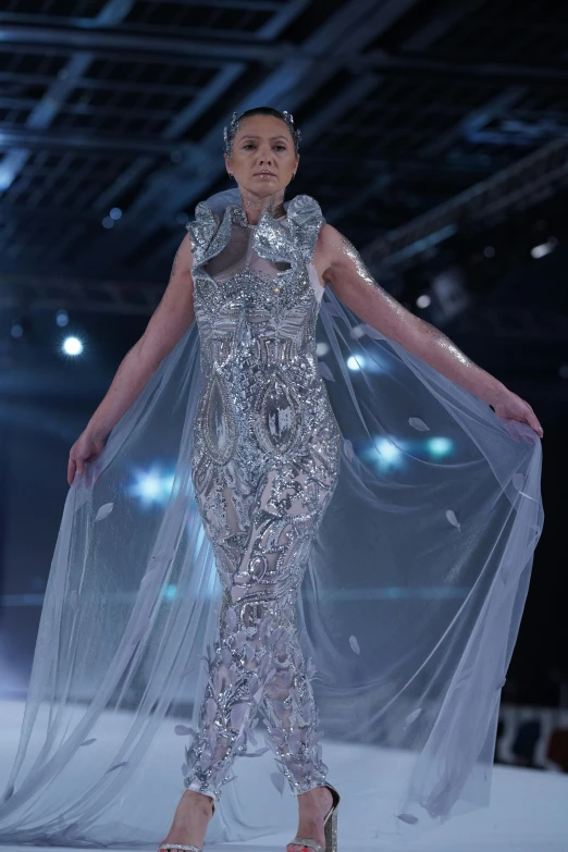 a woman on the runway wearing a dress