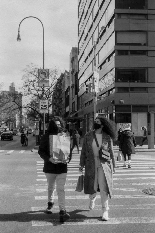 two people in a crosswalk that are not the same