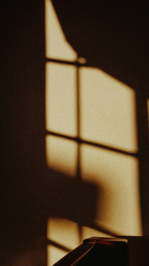 a shadow of the light coming in through a window