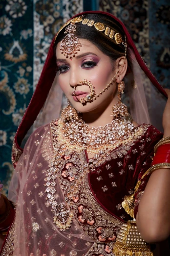 woman in elaborate outfit on cell phone with nose ring and jewelry