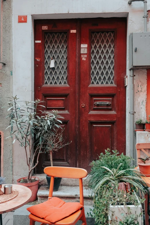 several chairs, a table and other items outside a building