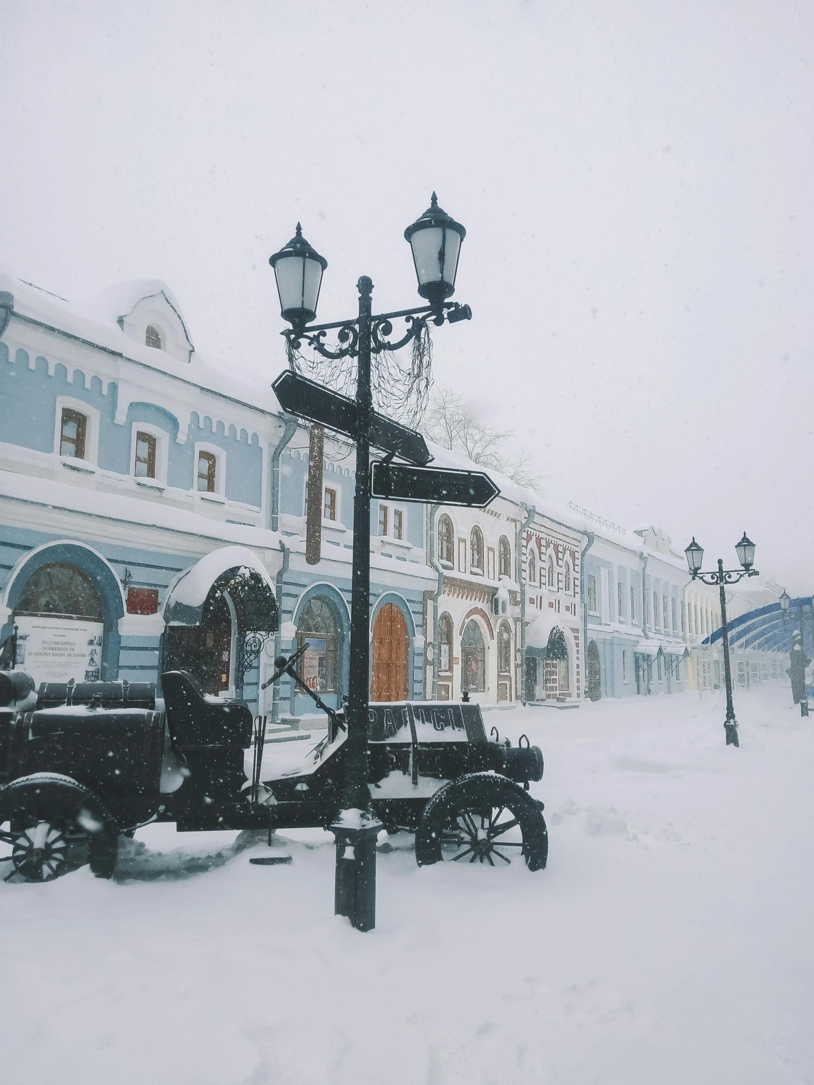 a light post in the middle of some snow covered streets