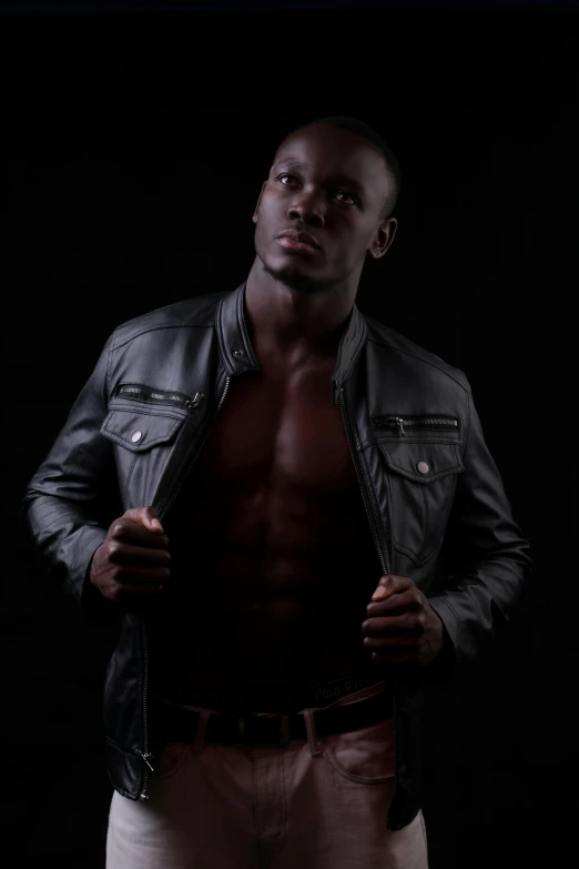 a man in a leather jacket posing for a po