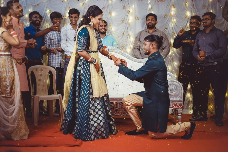 a man placing a ring on the hands of a woman