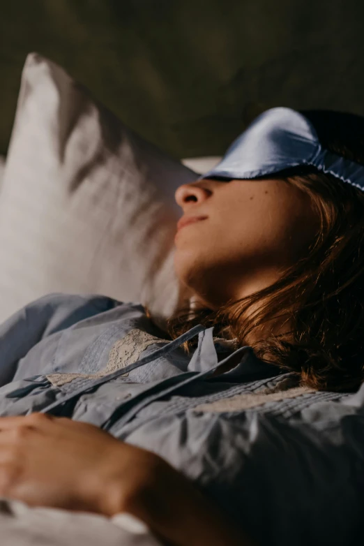 woman lying on a couch sleeping with her head propped up on her pillow