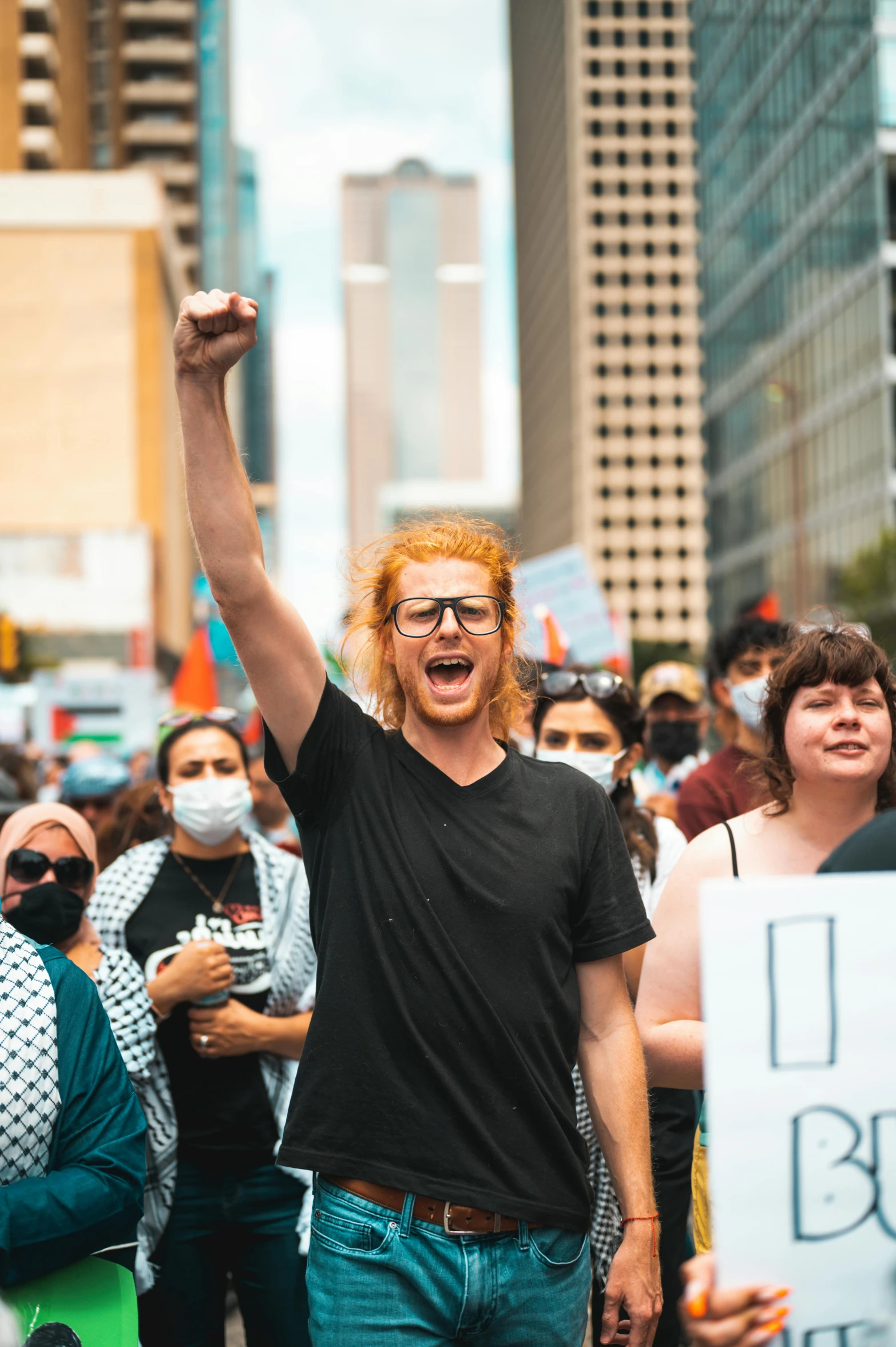 a man waving with both hands in the air