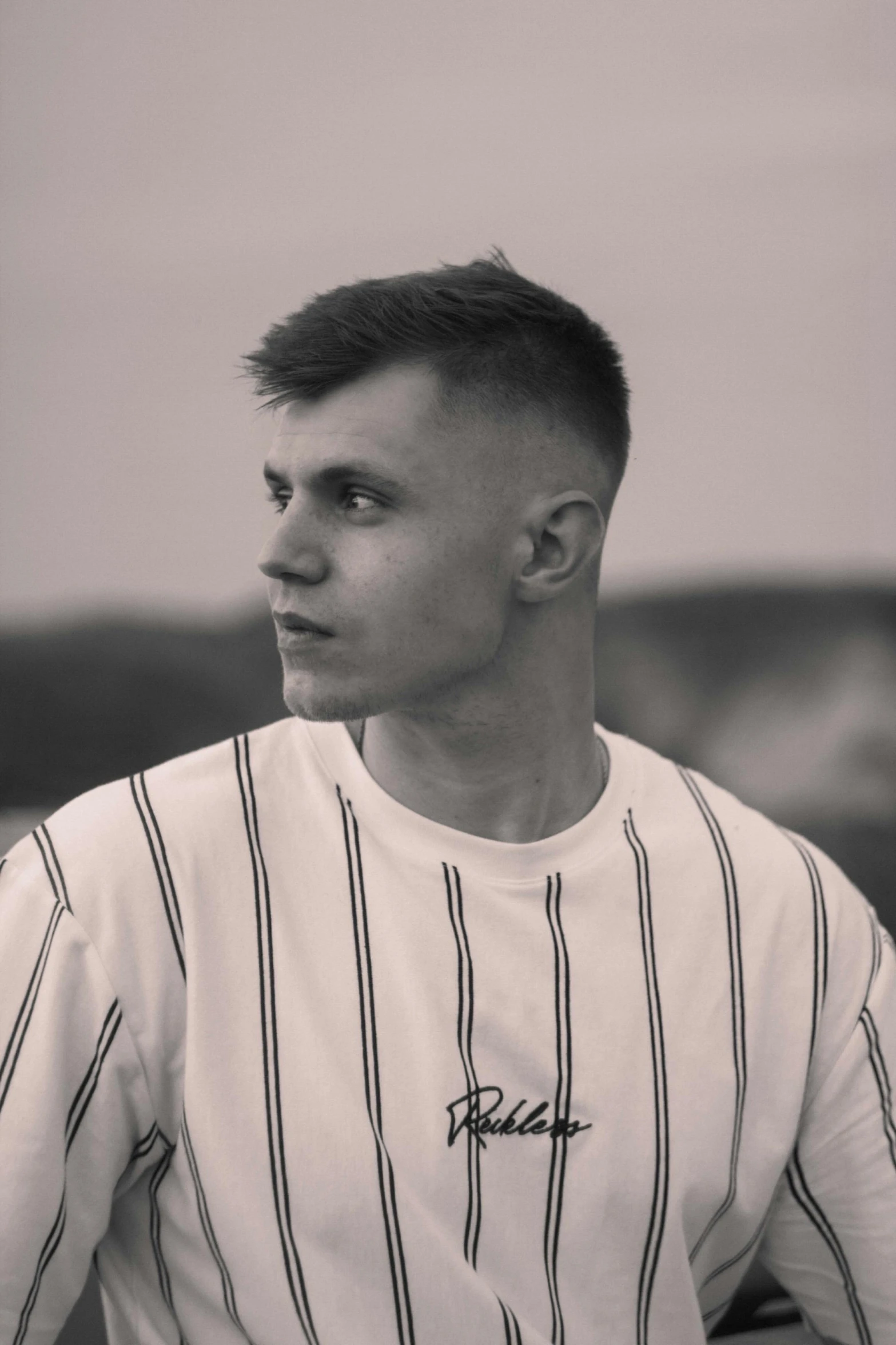 a man with an old style baseball uniform looking to his left