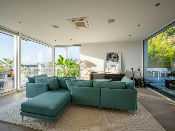 a large blue sectional sofa with matching footrests