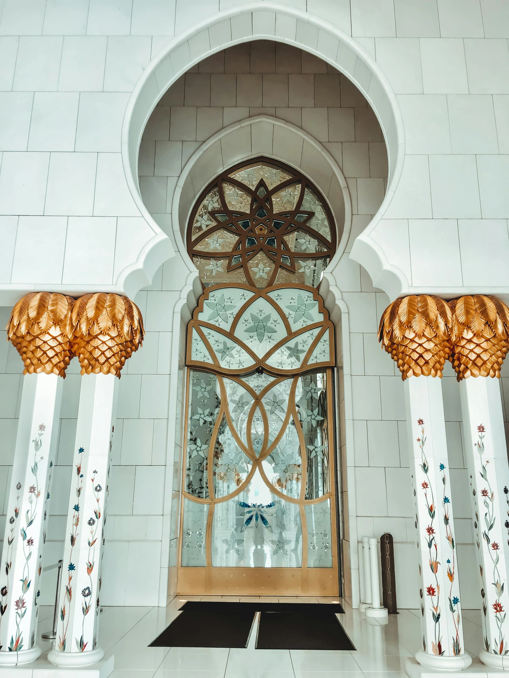 a doorway to a room with pillars and a circular window