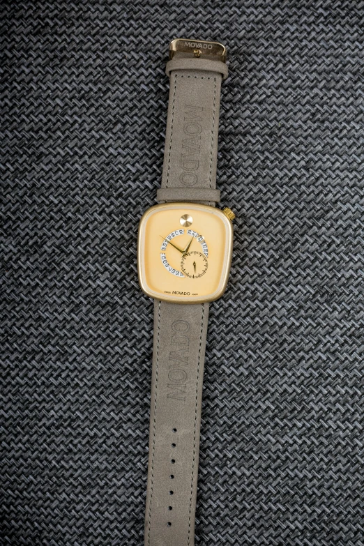 a watch sits on a piece of cloth