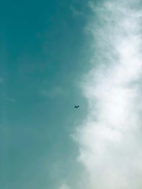 an airplane flying in the sky in the day