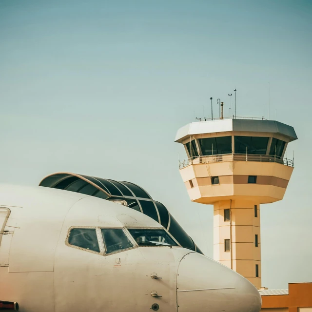 there is a plane with a tower behind it