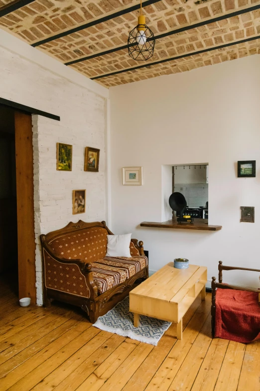 a living room with a wood floor and brick ceiling