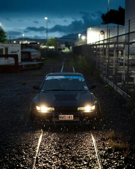 a car driving down the tracks at night