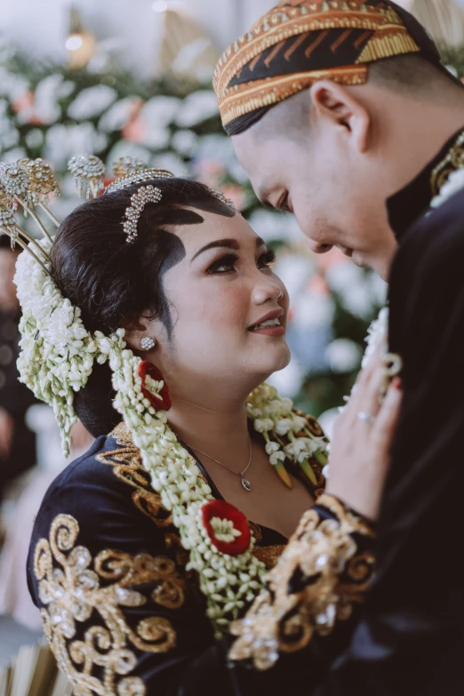 a couple pose together for a po in traditional costumes