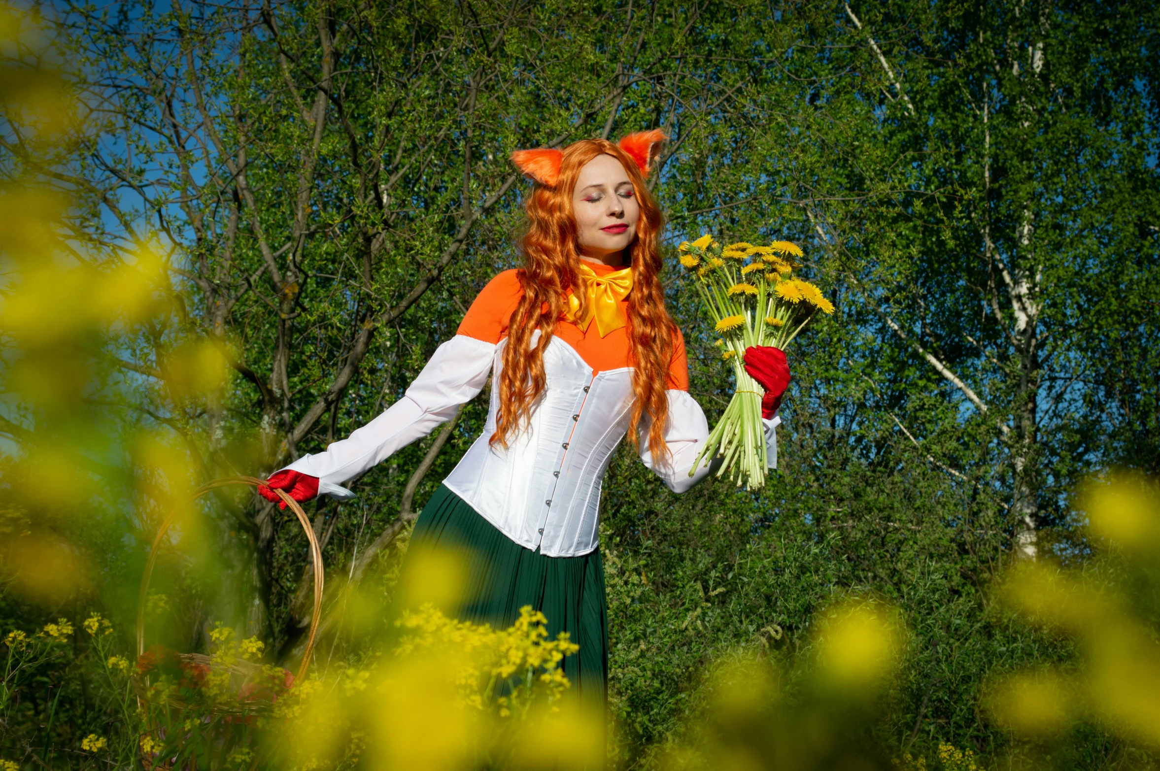 an anime girl with red hair wearing an orange and white costume in the woods