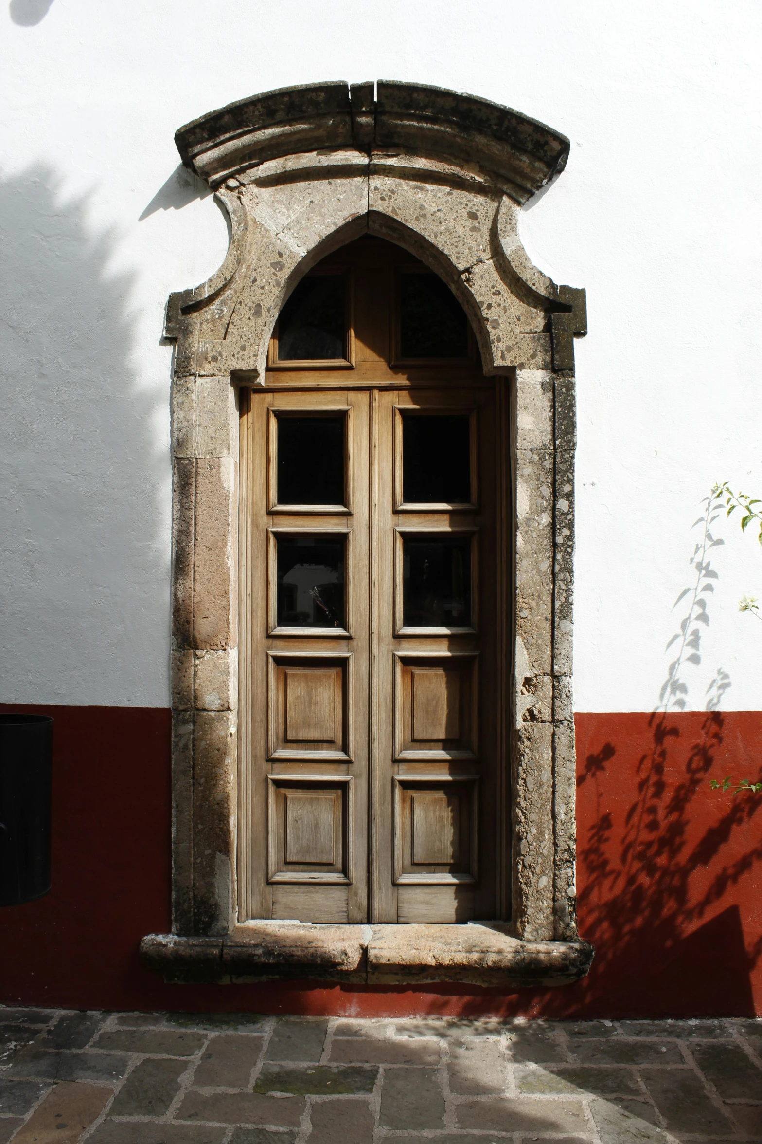 a door in the side of a wall with red bricks