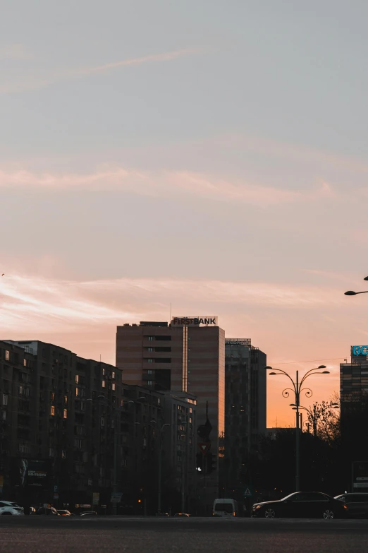 an airplane flying in front of a large city with many buildings