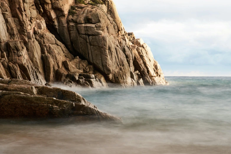 a view of the ocean from below rocks