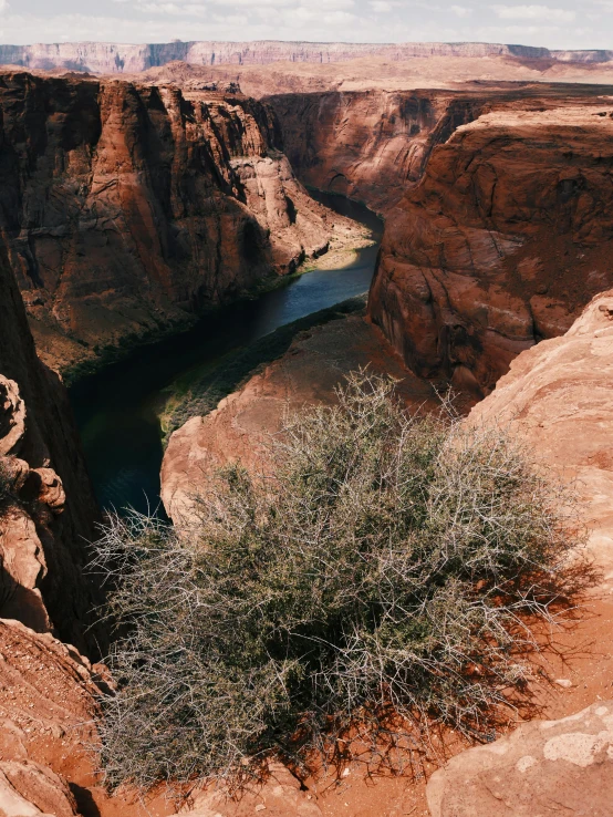 a large canyon next to water and rocks