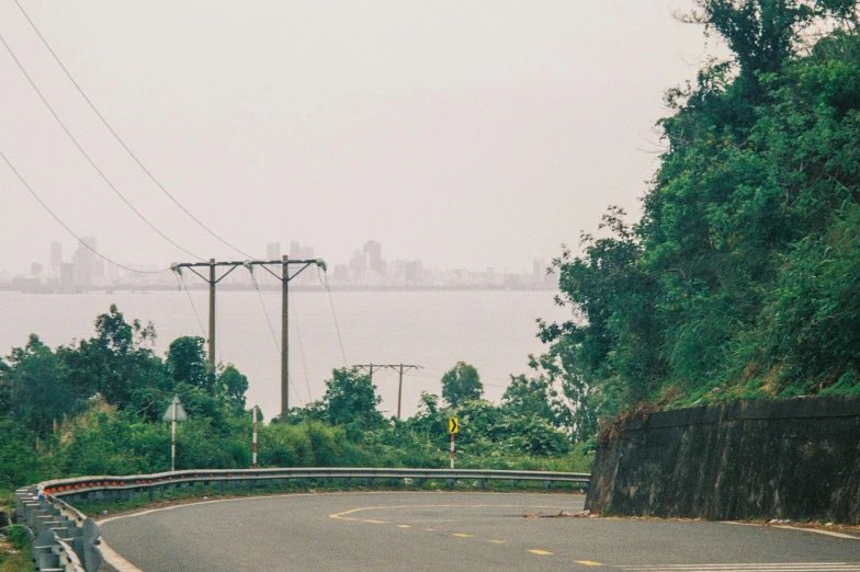 two street signs sit on an empty road