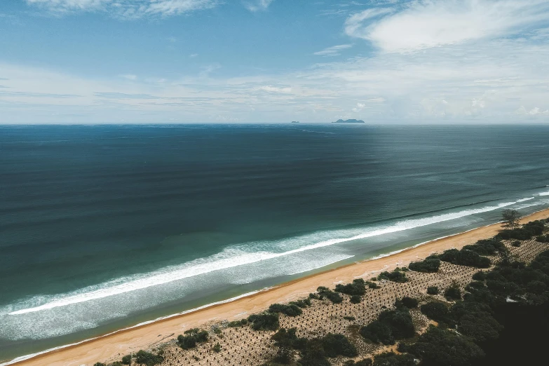 an aerial s of an ocean and a boat in the distance