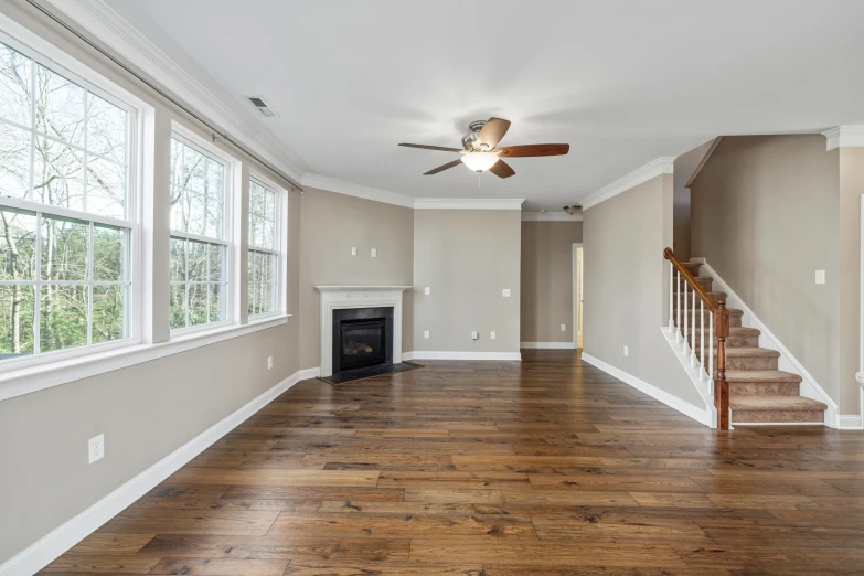 an empty house with wooden floors and a staircase