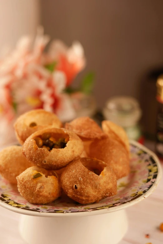 small food on a round plate in front of a flowered table